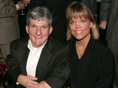 Amy Roloff  is wearing a black dress and Matthew Roloff is wearing a black suit and a white shirt.